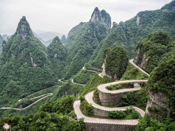 A view of the dangerous  99 curves at the Tongtian Road to Tianmen Mountain, The Heaven's Gate at Zhangjiagie, Hunan Province, China, Asia A view of the dangerous  99 curves at the Tongtian Road to Tianmen Mountain, The Heaven's Gate at Zhangjiagie, Hunan Province, China, Asia zhangjiajie photos stock pictures, royalty-free photos & images