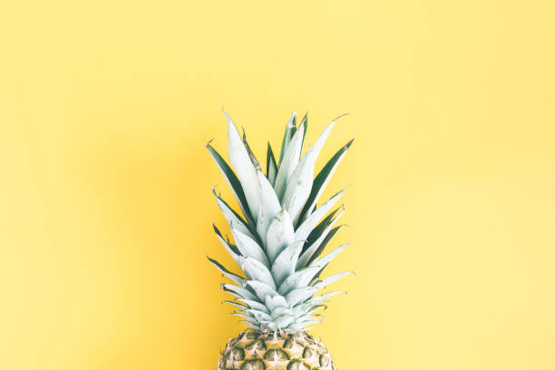 istock Pineapple on yellow background. Summer concept. Flat lay, top view 972518160