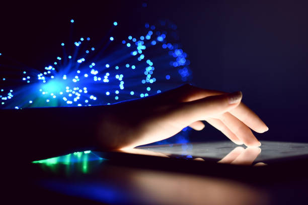 istock Woman Hand Touching Tablet Screen Browsing Internet On Blurry Fiber Optic Bokeh Background Technology Concept Close Up 972523612