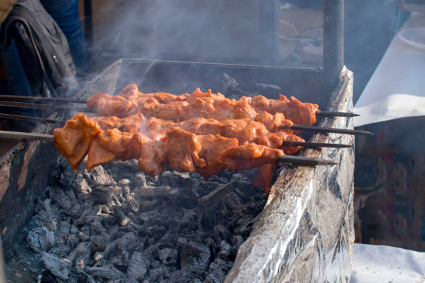 istock Chicken kebabs being grilled on charcoal 972534910