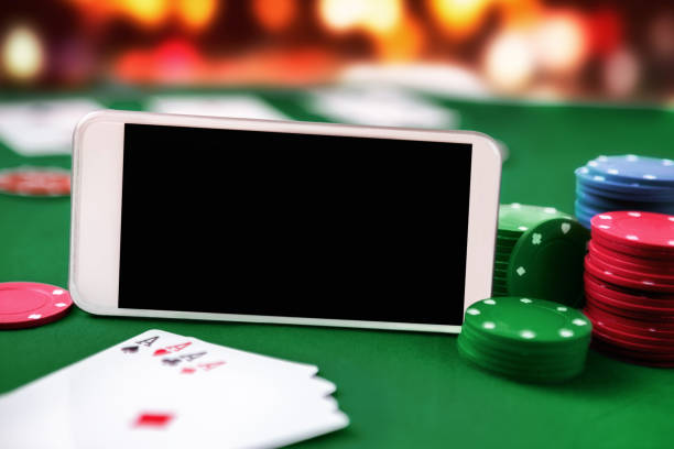 istock Smartphone with chip cards and four aces 972538462