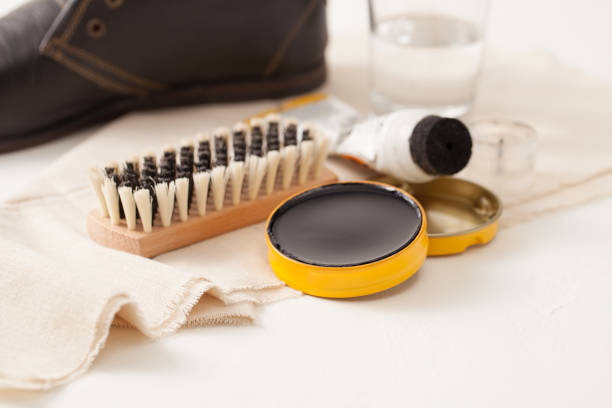 Shoe cream and a brush with a rag to care on a white background. Shoe care cream. Use of eco-friendly materials in Shoe Polish. shoe polish stock pictures, royalty-free photos & images