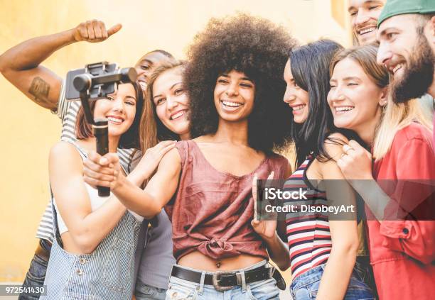 Happy Millennials Friends Making Video Feed With Smartphone Outdoor Young People Having Fun With New Technology Trends Youth Lifestyle And Social Media Concept Focus On Black African Girl Face Stock Photo - Download Image Now