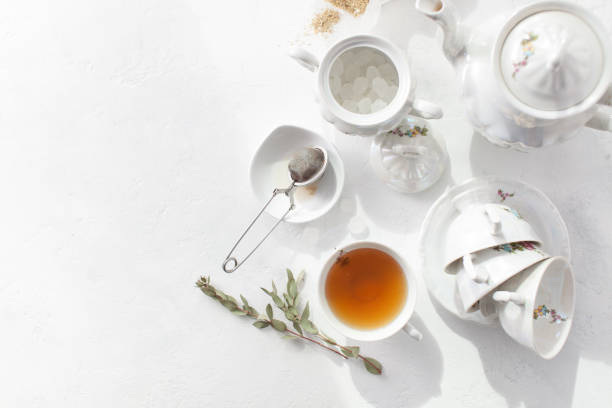 istock Tea in a Cup with dry flowers on a white table. Copy space text 972541844