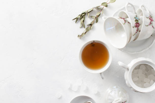 istock Tea in a Cup with dry flowers on a white table. Copy space text 972542018