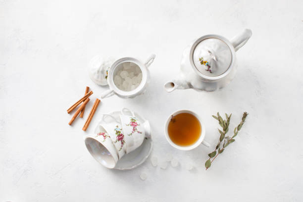 istock Tea in a Cup with dry flowers on a white table. Copy space text 972542154