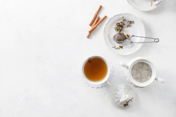 istock Tea in a Cup with dry flowers on a white table. Copy space text 972544418