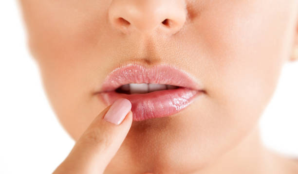 istock Woman touching her lips with herpes 972557080