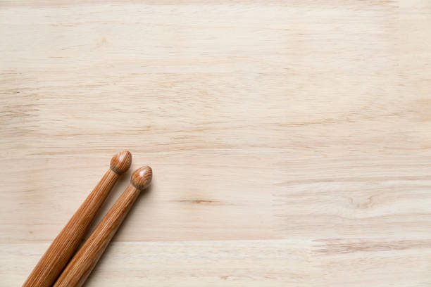 Drum stick on wooden table background, top view, music concept