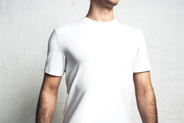 istock Young athletic man in white blank t-shirt, horizontal studio close-up, empty wall 972559830