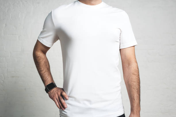 istock Young athletic guy wearing blank white t-shirt, studio close-up, empty wall 972560088