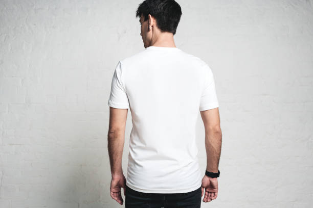 istock Young guy wearing blank white t-shirt, back side, horizontal studio portrait 972560184