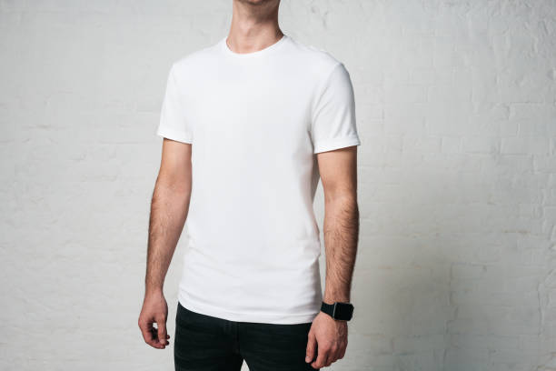 istock Young man in white blank t-shirt, horizontal studio portrait, empty wall 972561480
