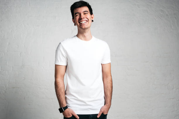 istock Smiling young guy in white t-shirt, studio portrait 972562604