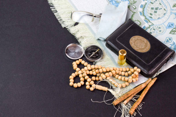 istock prayer beads, siwak, perfume and book, muslim compass 972563124