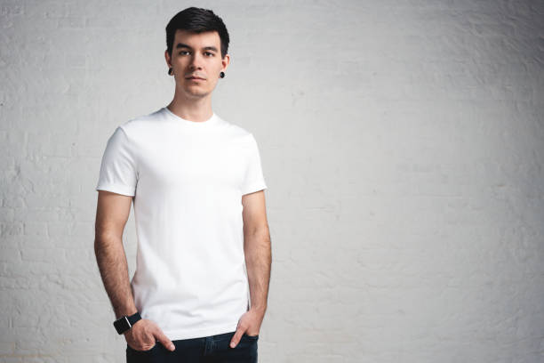 istock Stylish young guy wearing white blank t-shirt, horizontal studio portrait 972565728