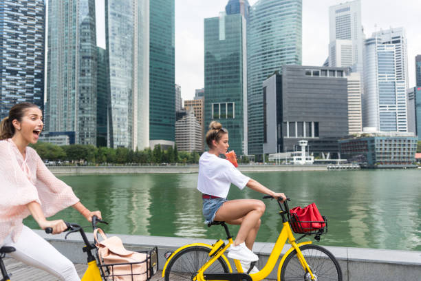 istock Girlfriends biking in downtown district 972566664