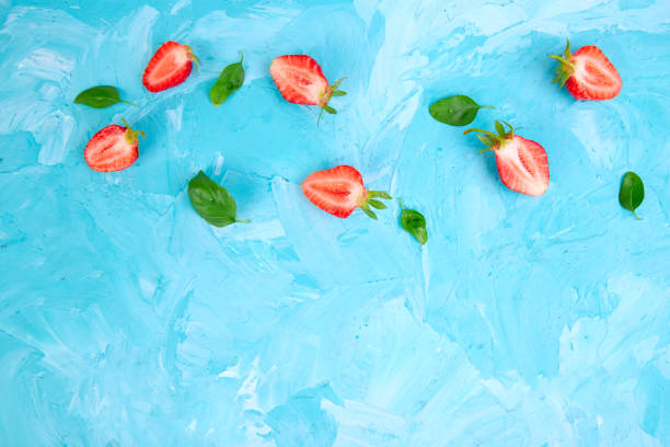 istock Strawberry and basil on blue background 972569102