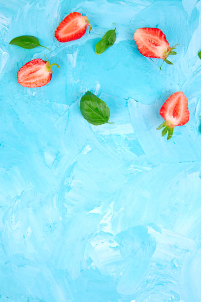 istock Strawberry and basil on blue background 972569108