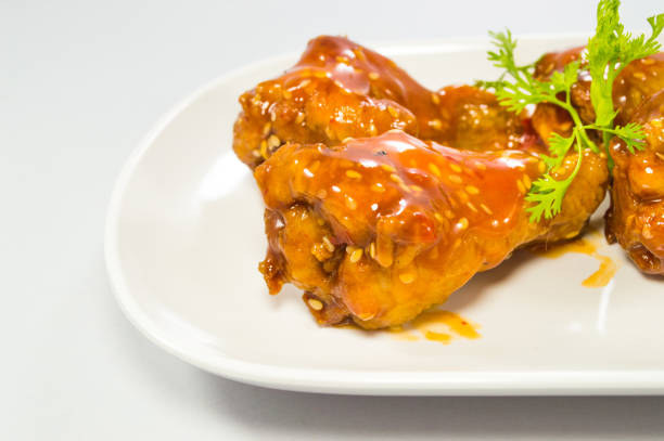 istock Korean sauce fried chickens in the dish on  isolated white background 972569330