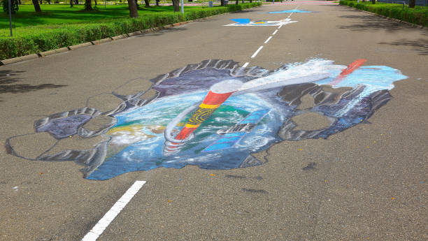 3d straße anamorphotische malerei auf asphalt in einem park.  asphalt-kunst-konzept. malediven, hulhumale stadt. - anamorphotischer stock-fotos und bilder