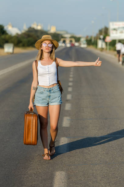 istock Woman hitchhiking 972578620