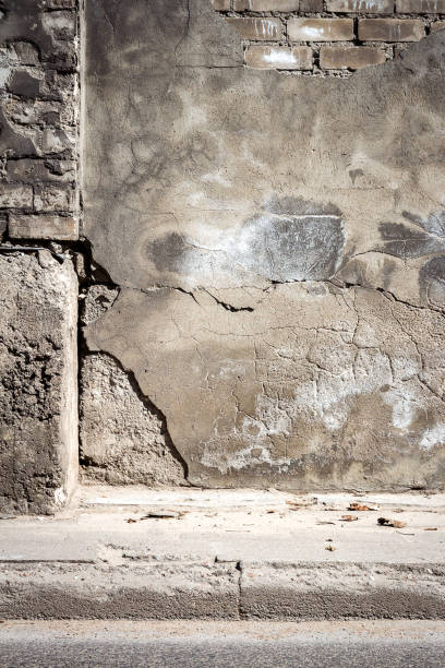 istock Old cracked plaster and brick wall 972578830