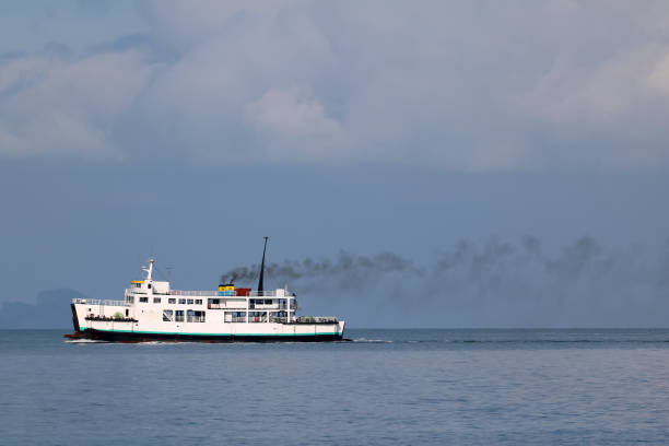 istock Ferry sailing in the sea and pollution from the engine 972579212