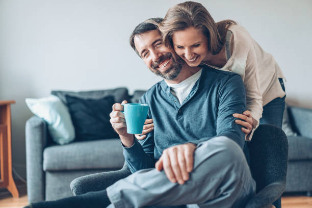 Affectionate moment Happy middle aged couple at home cheek to cheek photos stock pictures, royalty-free photos & images