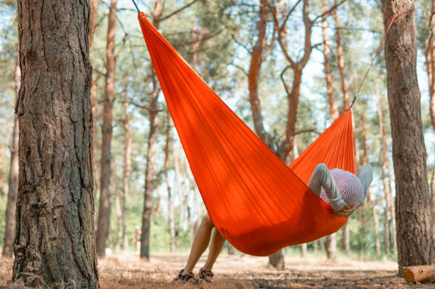 istock Young woman relaxing in hammock 972590798