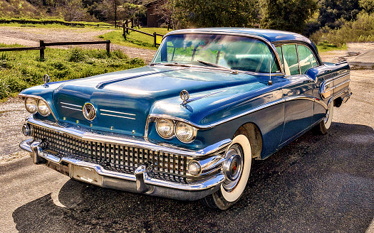 Classic Buick 1958 automobile, blue, with natural background.