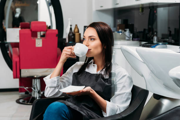 istock hairdresser drinking coffee during lunch time 972596234