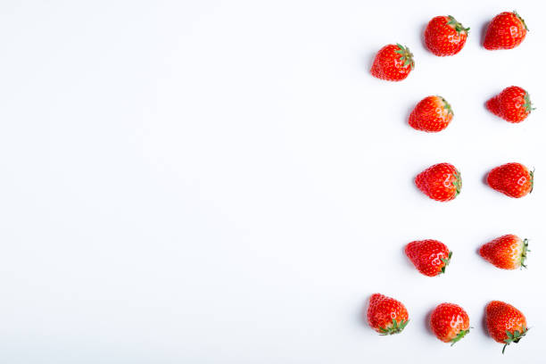 istock Strawberry on white background, top view. Berries pattern, flat lay. Fresh strawberry isolated on white background. Creative food concept 972596530