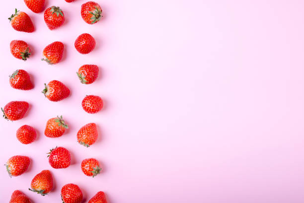 istock Strawberry on pastel pink background, top view. Berries pattern. Fresh strawberry flat lay. Creative food concept 972596770