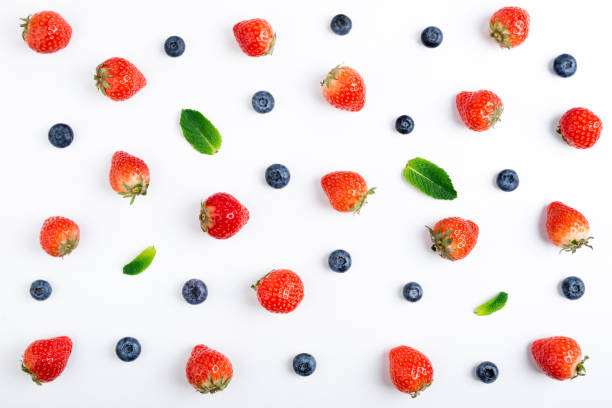 istock Strawberry, blueberry and mint leaves on white background, top view. Berries pattern, flat lay. Strawberry, blueberry, mint leaves isolated on white background. Creative food 972596852