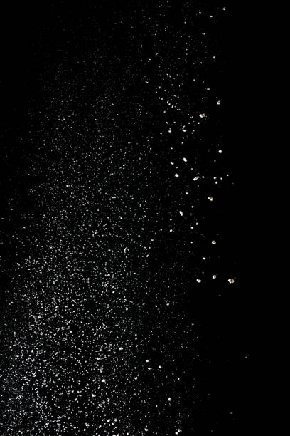 istock White powder splash isolated on black background. Flour sifting on a black background. Explosive powder white 972597006