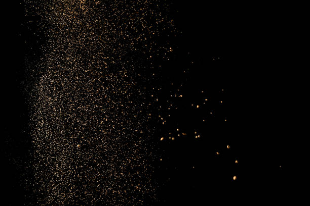 istock Cocoa powder sifting isolated on black background. Chocolate dust on black background 972597062