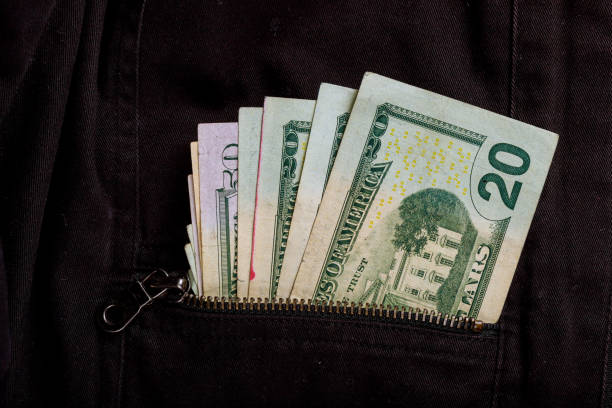 istock Dollar banknotes are in jeans back pocket closeup shot 972599364