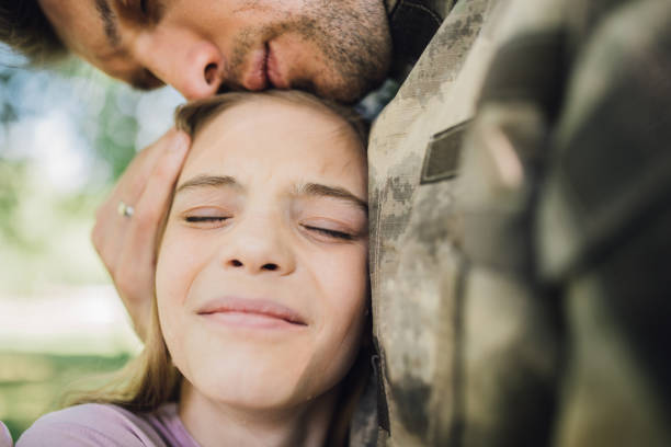 istock Desperate soldier comforting crying daughter 972599470