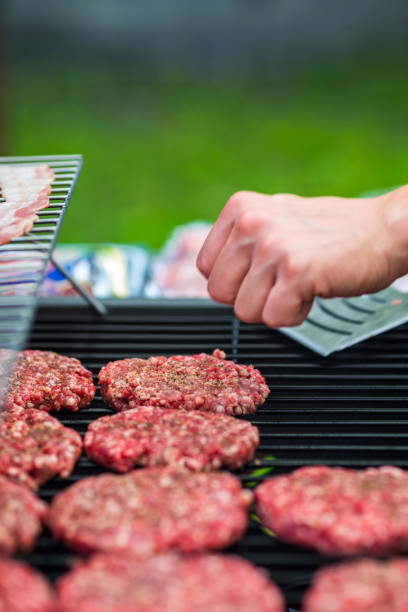 istock Making hamburgers on the grill 972600194