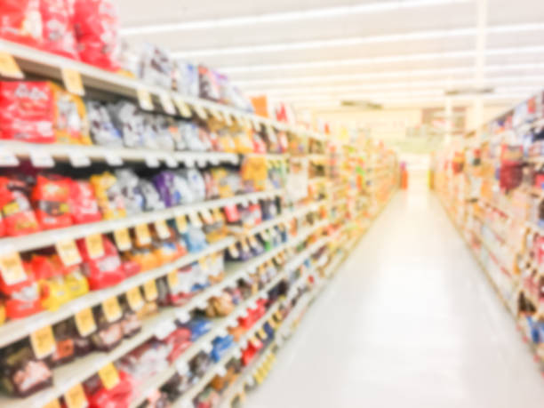 istock Abstract blurred candy, chips, cookies at grocery store in USA 972612756