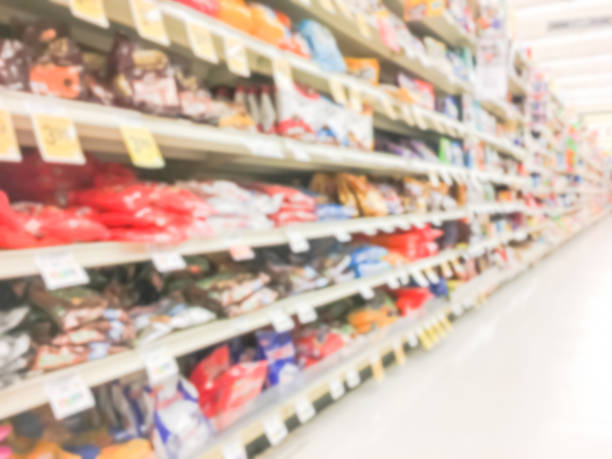 istock Abstract blurred candy, chips, cookies at grocery store in USA 972613094