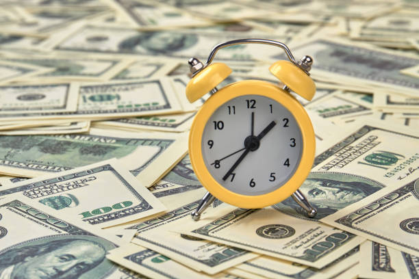 istock Alarm clock and dollars, close up. 972617466