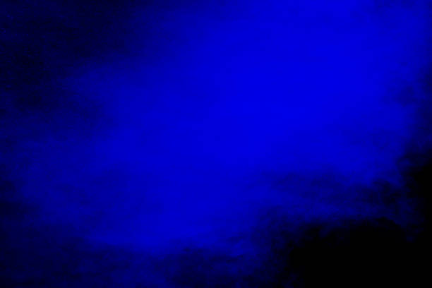 istock abstract blue dust explosion on  black background ,abstract blue powder splattered on black background , Freeze motion of blue powder exploding. 972620850