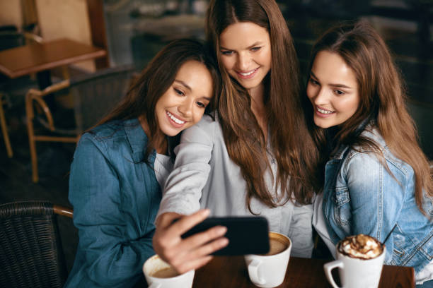 istock Friends Having Fun, Taking Photos In Cafe. 972621000