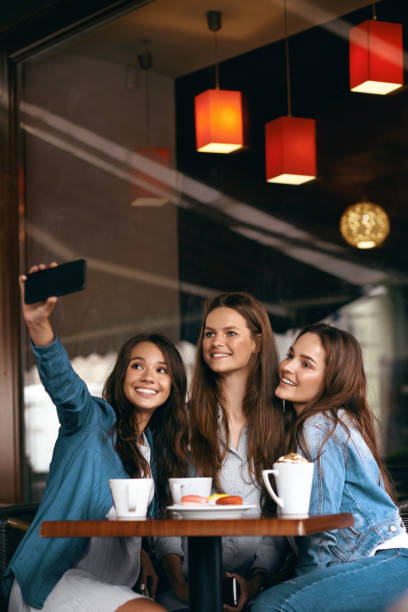 istock Friends Having Fun, Taking Photos In Cafe. 972621218