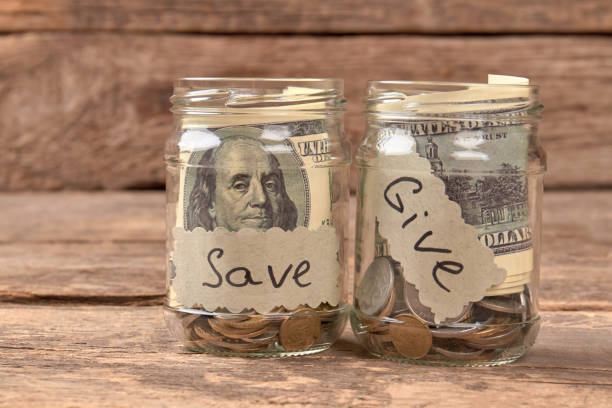 istock Two glass tins as moneyboxes. 972621244