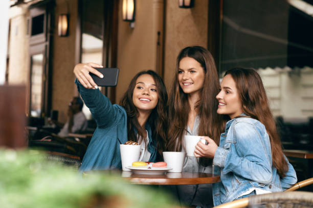 istock Friends Having Fun, Taking Photos In Cafe. 972621694