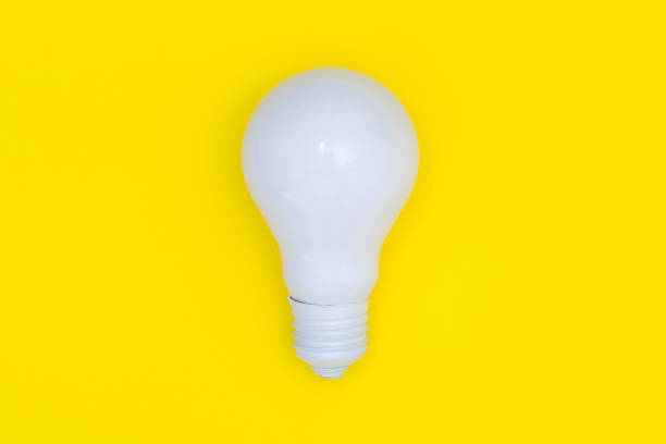 istock White light bulb isolated on yellow background, Top view, Minimal concept, Creative idea and innovation 972626728