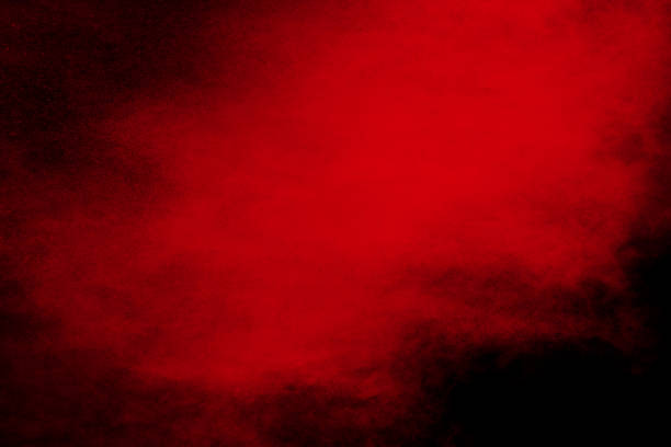 istock abstract red powder explosion on black background. abstract red dust splattered on background. Freeze motion of red powder splashing. 972626962
